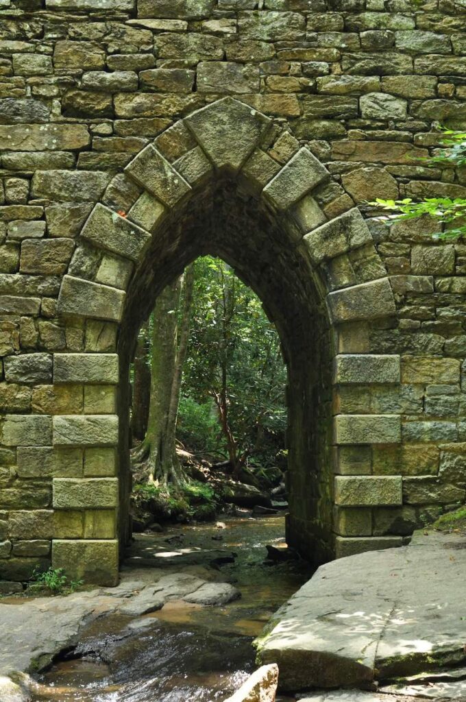 A closeup shot of Poinsett Bridge's gothic arch. The arch has a point at the top and is made of stone.