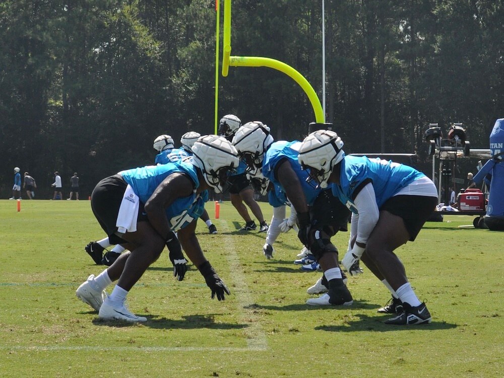 Carolina Panthers players practice tackling during training camp at Wofford College.